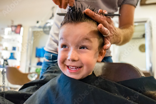 Cute Child Get a Haircut at the Barbershop photo