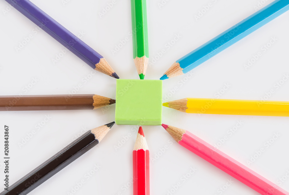 Group of graphite and color pencil, green rubber on white background with space copy Group of graphite and color pencil, green rubber on white background with space copy