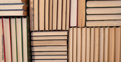 background. a lot of neatly stacked books on the shelf