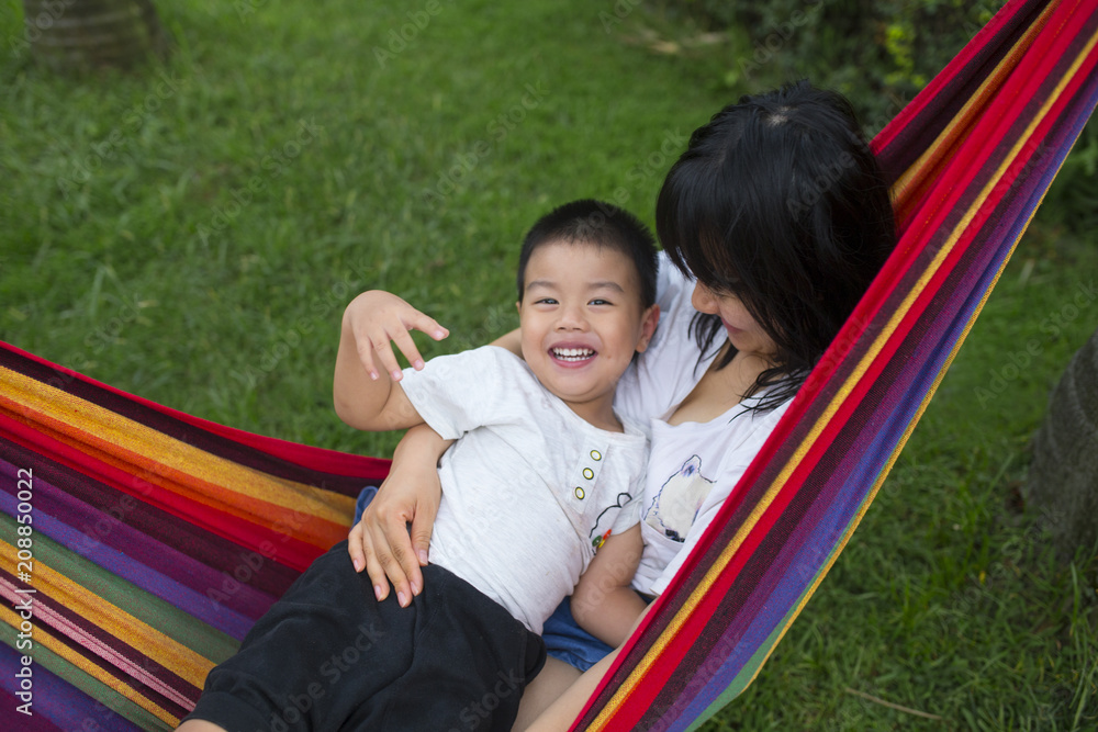 little boy with her mother in the hammock little boy with her mother in the hammock