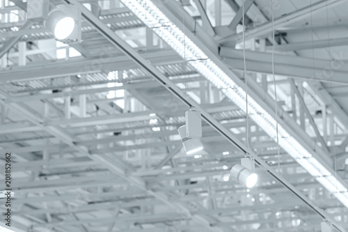 row of bright halogen spotlights on exhibition ceiling. industrial building interior