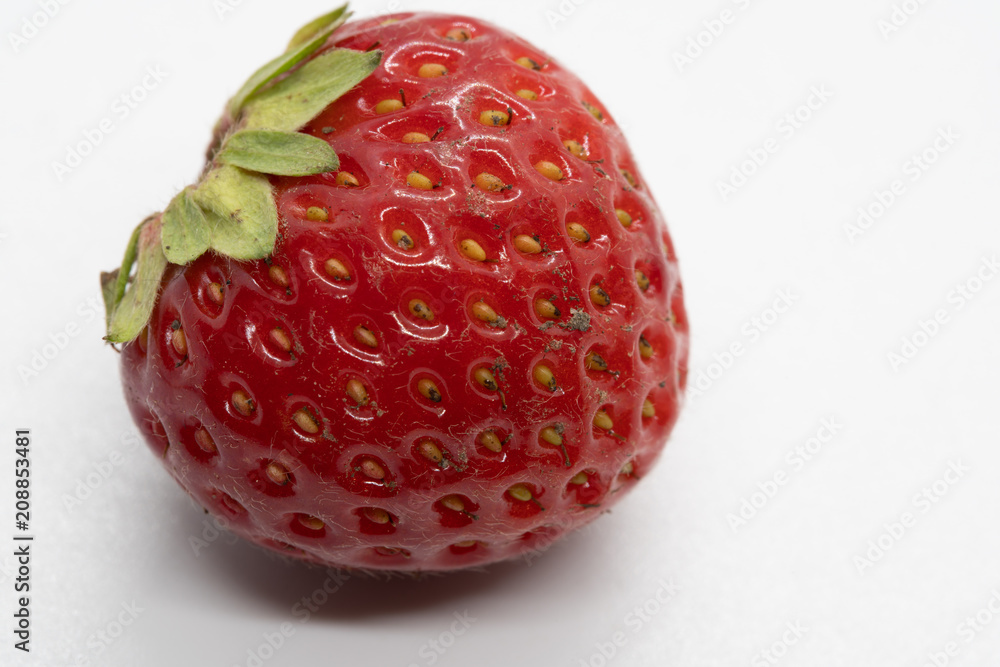 Dirty red ripe strawberry with dust speckles Dirty red ripe strawberry with dust speckles
