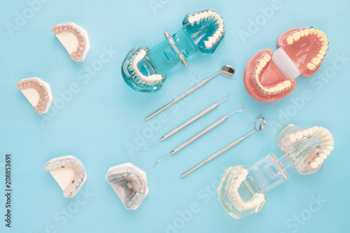 dentist tools and orthodontic on the blue background, flat lay, top vipw.