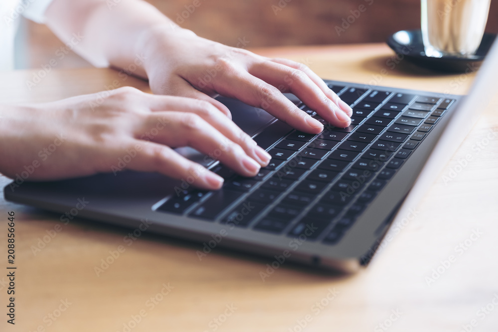 Closeup image of hands working and typing on laptop keyboard in office Closeup image of hands working and typing on laptop keyboard in office
