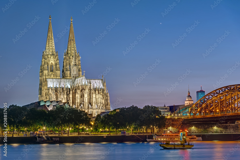 The famous Cologne Cathedral and the river Rhine at night