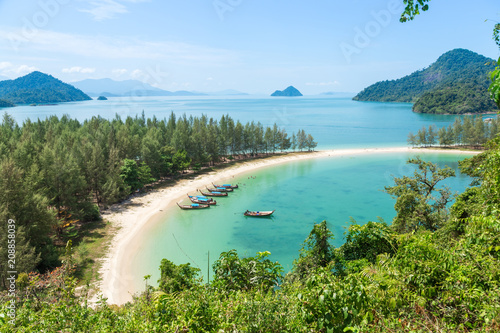 White sand beach and Long-tail boat at Kham-Tok Island (koh-kam-tok), The beautiful sea Ranong Province, Thailand.