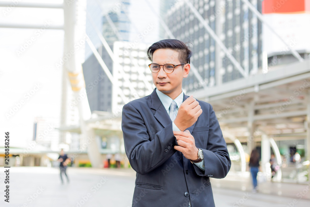 Asia young business man in front of the modern building in downtown .Concept of young business people Asia young business man in front of the modern building in downtown .Concept of young business people