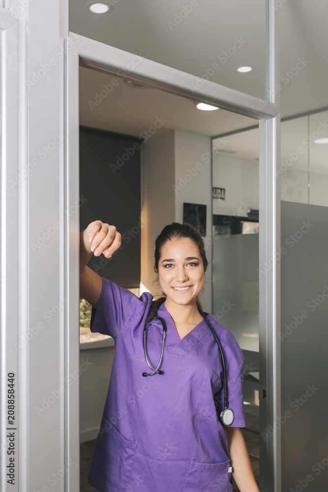 Young nurse in the clinic looking at camera Young nurse in the clinic looking at camera