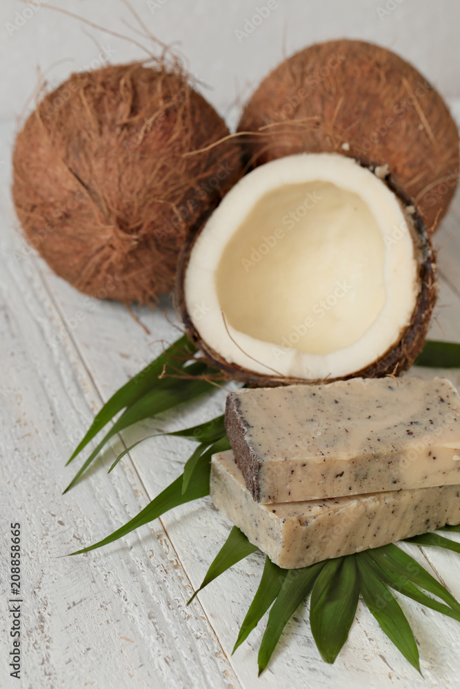 coconut soap.soap with coconut extract. Handmade soap with coconut oil on a palm leaf and fresh coconut in a cut on a shabby wooden background. Organic Cosmetics coconut soap.soap with coconut extract. Handmade soap with coconut oil on a palm leaf and fresh coconut in a cut on a shabby wooden background. Organic Cosmetics
