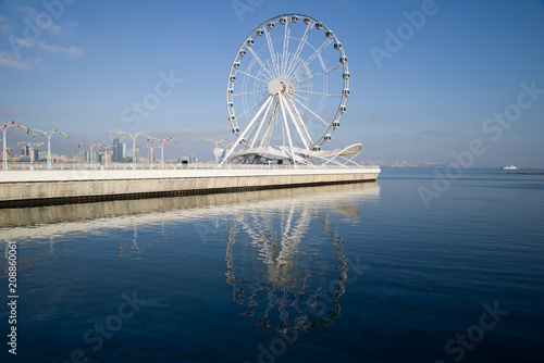 View of the Ferris wheel on the Caspian Sea embankment on a sunny December day. Baku, Azerbaijan © sikaraha