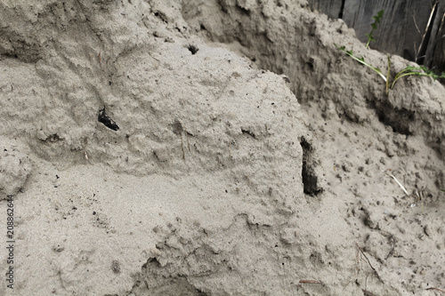 A pile of sand near fence
