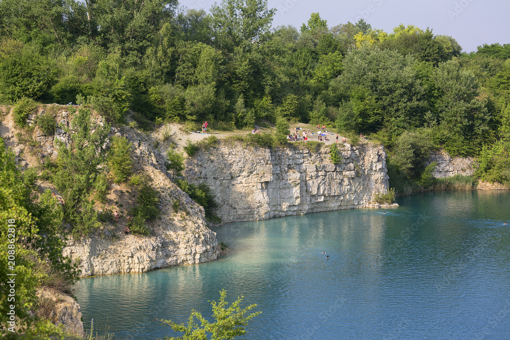 Lagoon Zakrzowek in an old limestone quarry, emerald water, resting people, Krakow, Poland