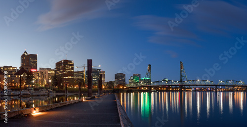 Portland city skyline at dusk with pier, river, and bridges