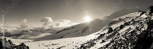 Sepia mountain landscape panorama with sunset and snow