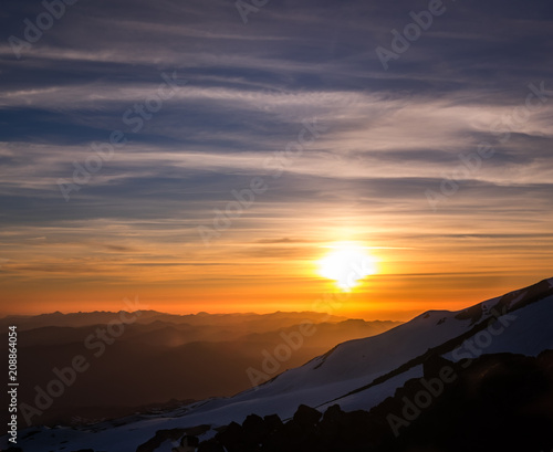 Mountain Sunet With Snow And Clouds