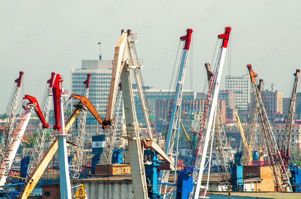 Port cranes, in the background the city is blurred due to the heat from