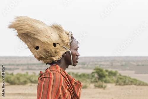 Maasai man with a lion's mane on his head photo