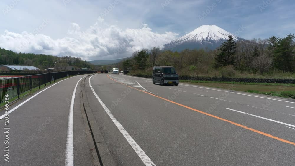 Cars Passing by Mt. Fuji in the Countryside of Japan Cars Passing by Mt. Fuji in the Countryside of Japan