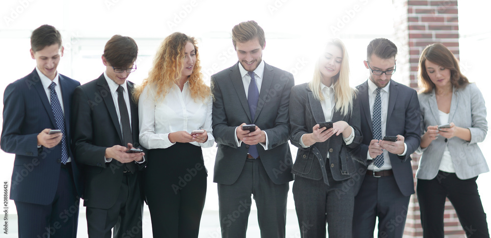 business team looking to smartphone in office business team looking to smartphone in office