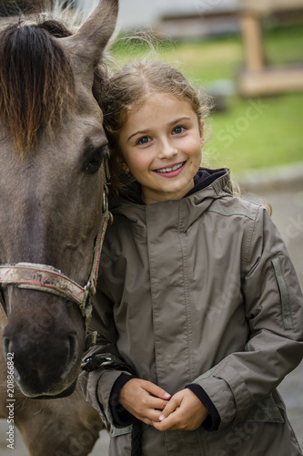 Young horse riding girl, equestrian sport . Horseback girl on field.