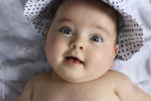 happy smiling baby with blue eyes on white background