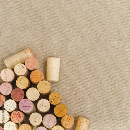 Wine corks close up on cloth  background with copy space. Multicolored corks from white and red wine bottles. Top view. photo