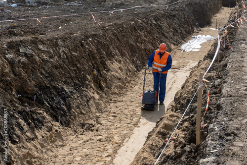 guest worker is building a trench sand stone earth