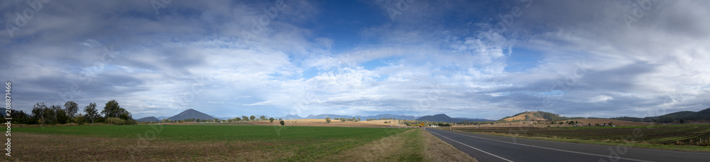 A cloudy winter sky over fields, farmlands adnd the mountains of the Great Dividing Range in Queensland, Australia