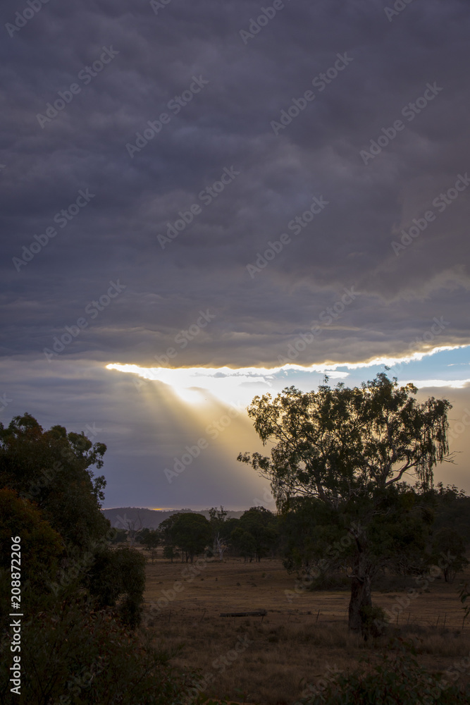 Last rays of sunlight over paddocks and fields on a chilly winters evening in Stanthorpe, Queensland, Australia