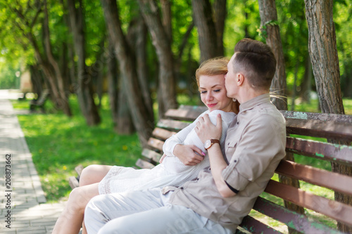 Beautiful couple perfectly spends time in the city park