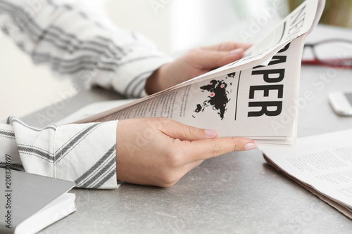 Woman reading morning newsp...