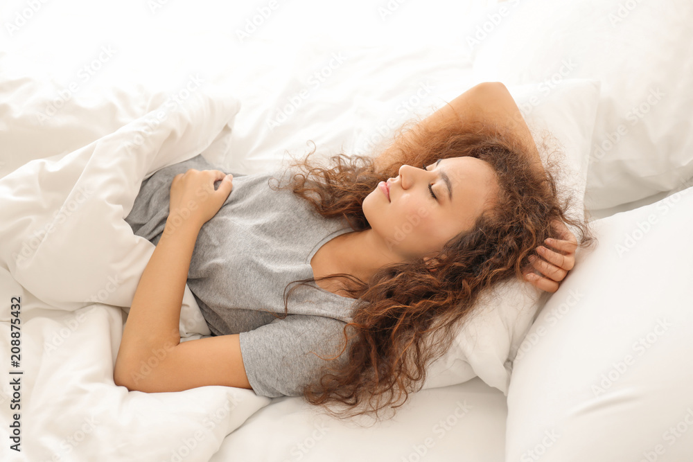 Morning of young African-American woman sleeping in bed Morning of young African-American woman sleeping in bed