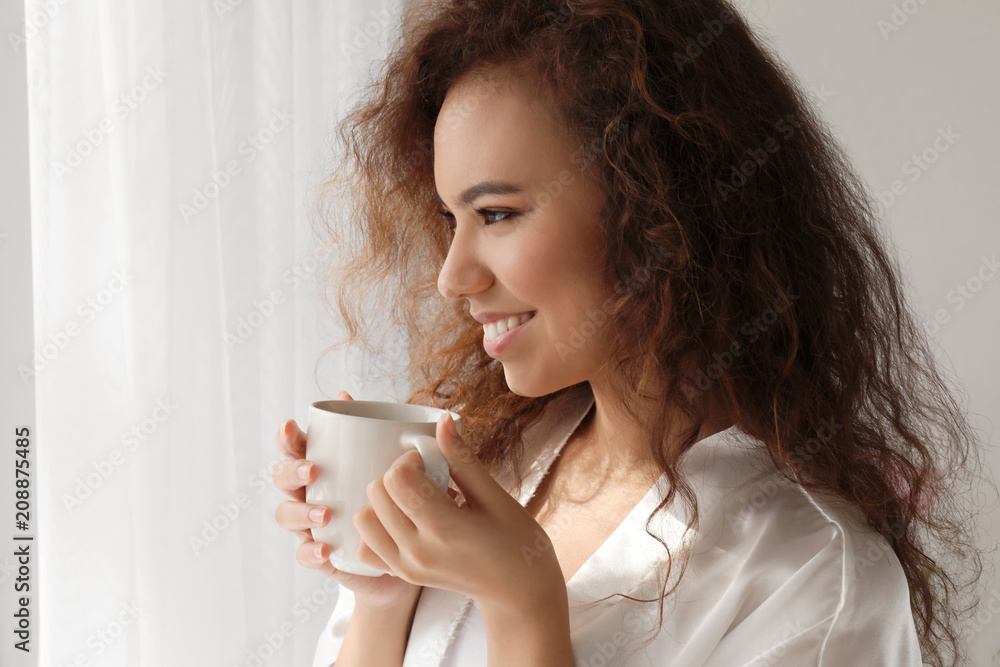 Morning of beautiful African-American woman drinking coffee at home Morning of beautiful African-American woman drinking coffee at home