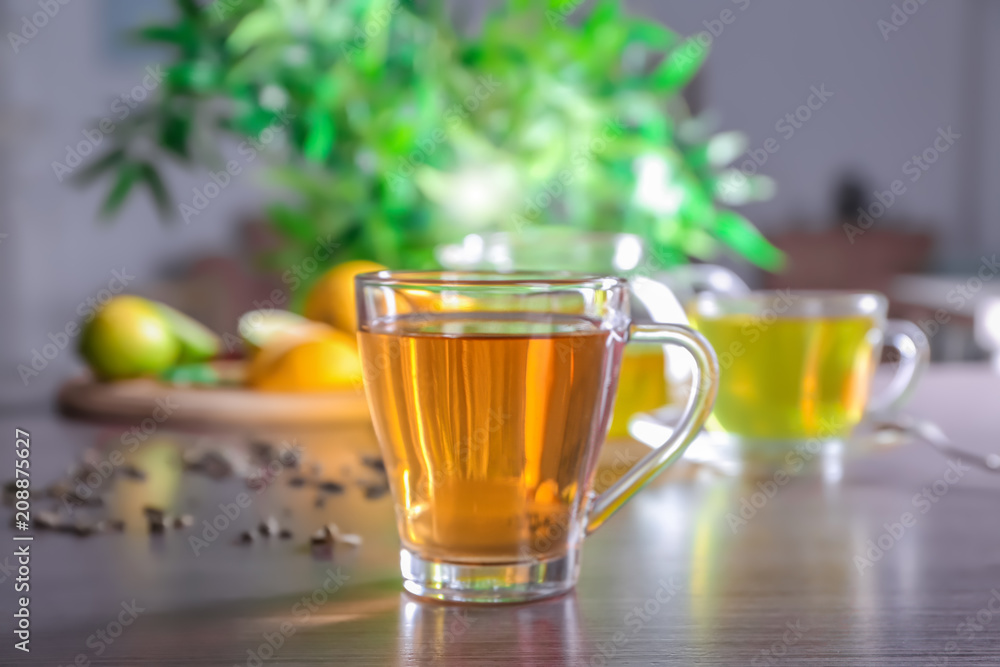 Glass cup with delicious tea on table Glass cup with delicious tea on table