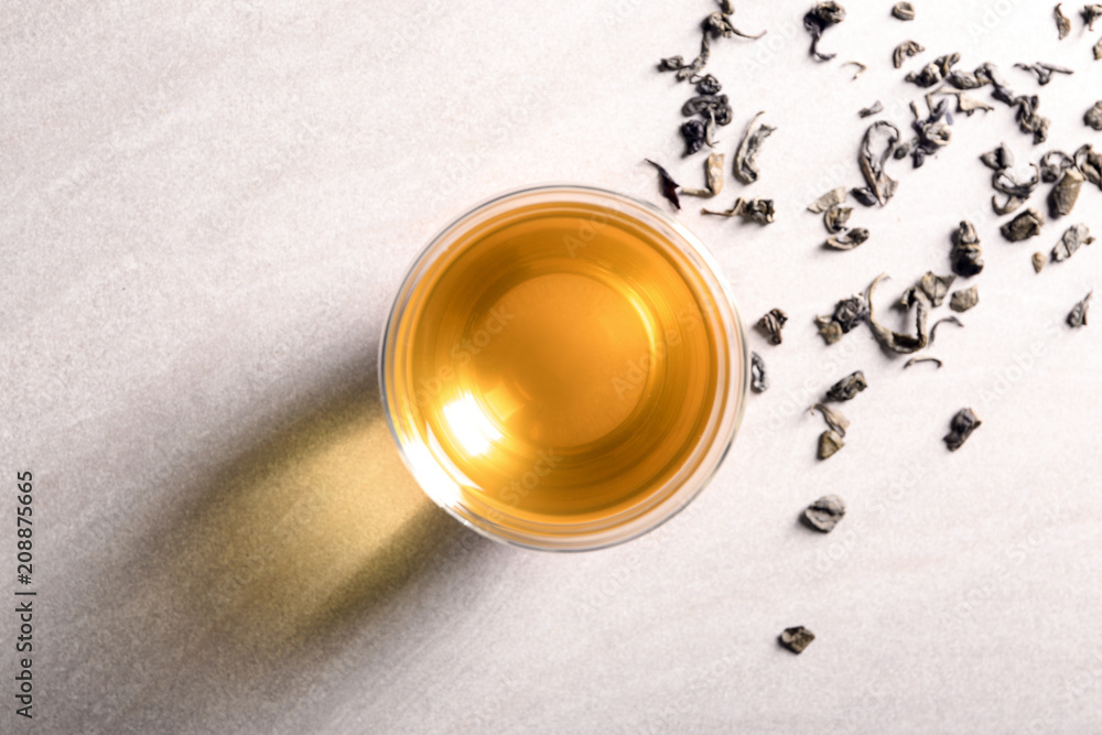 Glass with delicious green tea on light background, top view Glass with delicious green tea on light background, top view