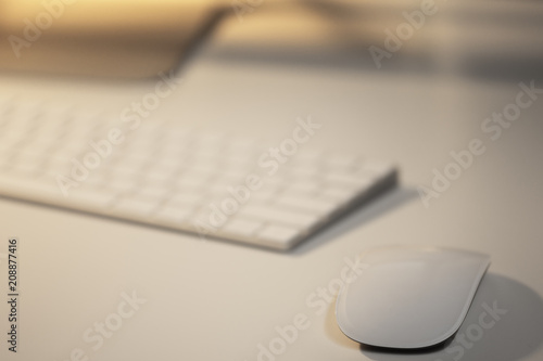 Mouse and keyboard on white table in office.