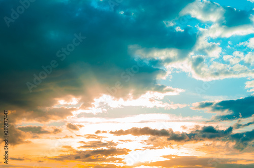 Storm clouds against a bright blue sky,sunset.