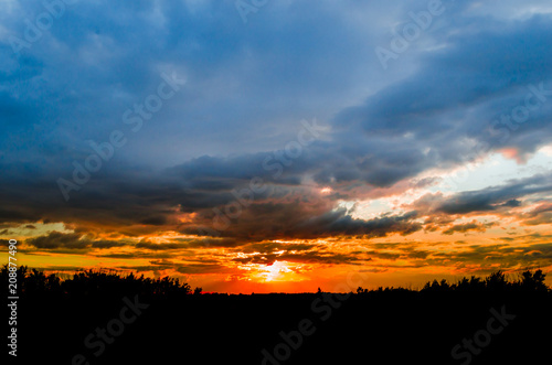 Storm clouds against a bright blue sky,sunset. © freeman83