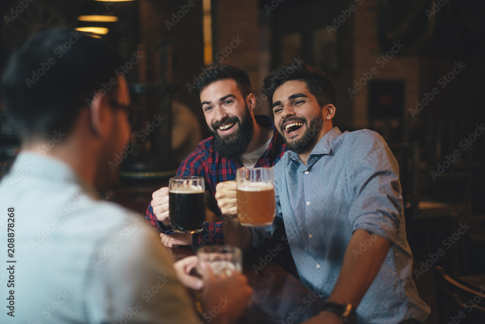 The guys in the pub are drinking beer
