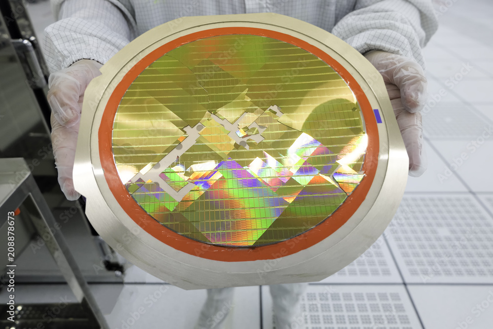engineer holding a silicon wafers broken from machine operation,working at clean room laboratory