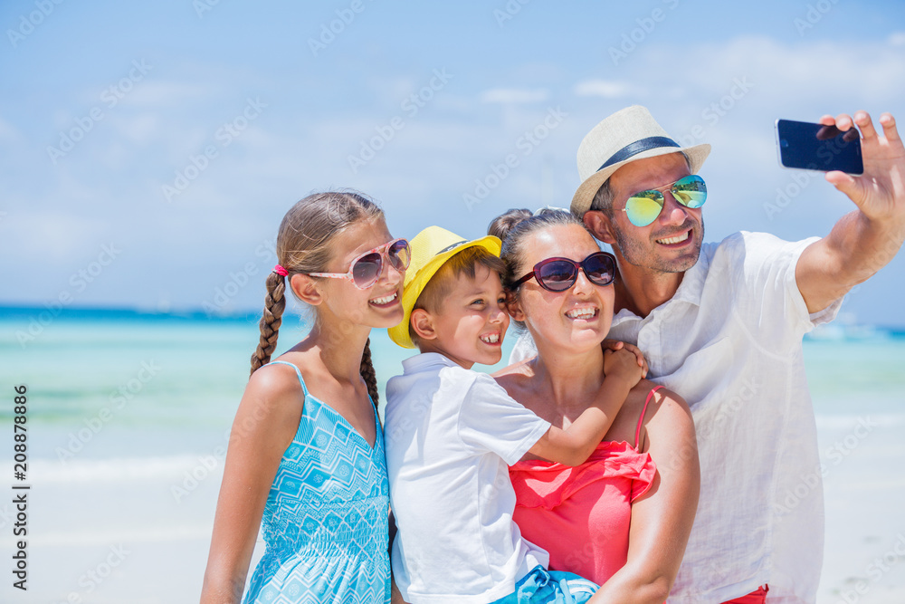 Family of four having fun at the beach Family of four having fun at the beach