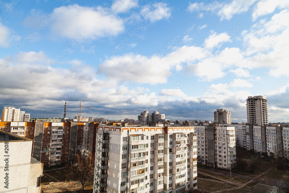 Quarter apartment buildings in background of cloudy sky