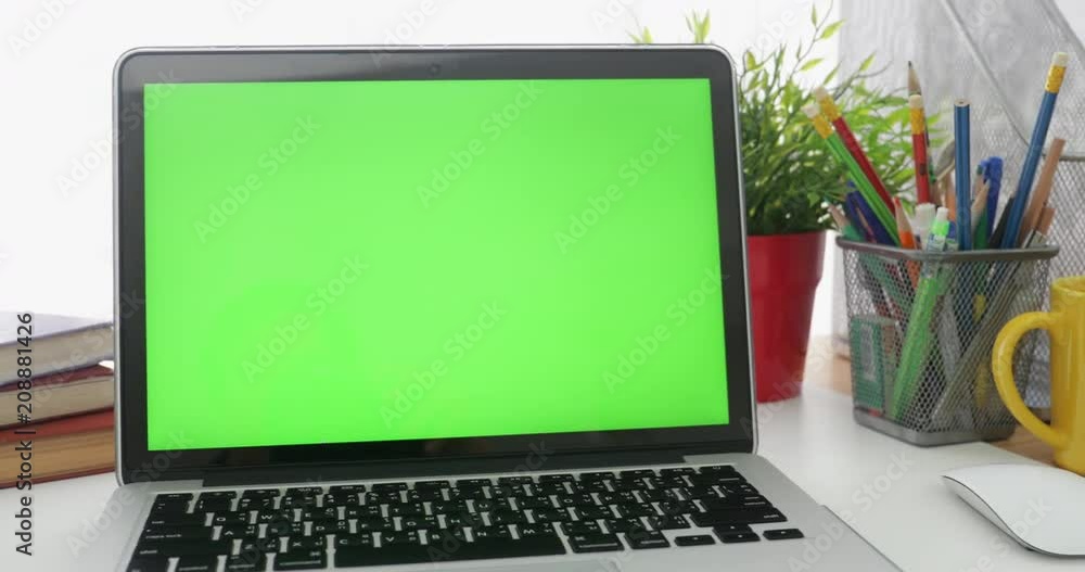 Dolly in of Laptop with green screen. Dark office. Perfect to put your own image or video.Green screen of technology being used. Chroma Key laptop Dolly in of Laptop with green screen. Dark office. Perfect to put your own image or video.Green screen of technology being used. Chroma Key laptop