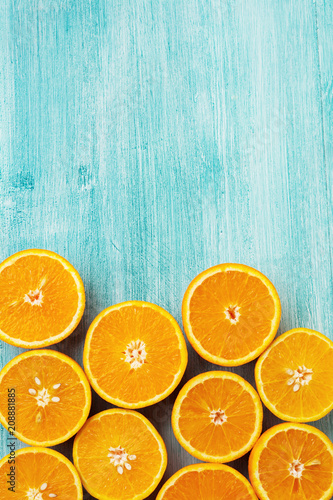 Orange slices flat lay on rustic blue wooden background. Top view.