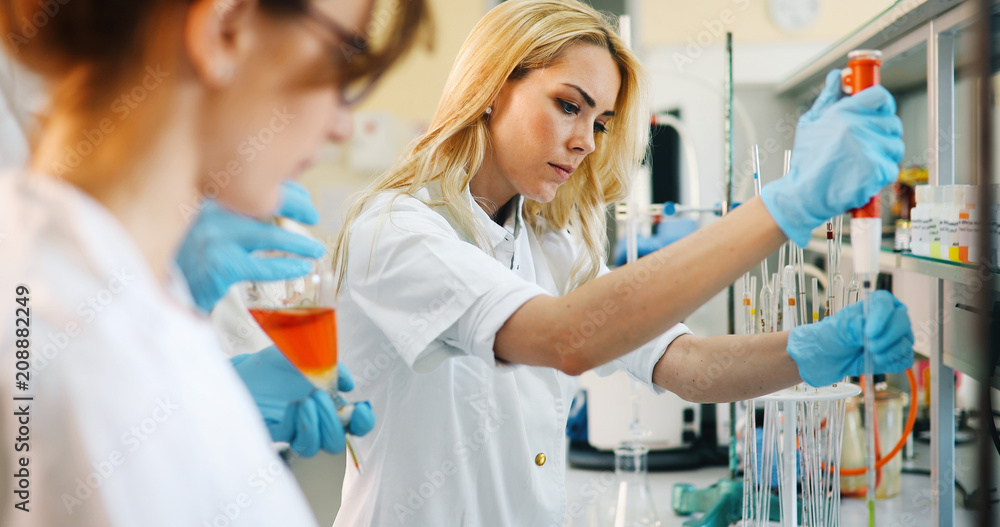Young students of chemistry working in laboratory Young students of chemistry working in laboratory