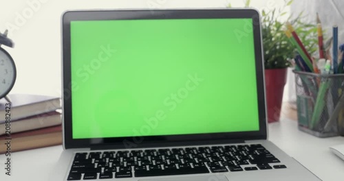 Wallpaper Mural Dolly shoot of laptop with green screen. Dark office.  Perfect to put your own image or video.Green screen of technology being used. Chroma Key laptop Torontodigital.ca