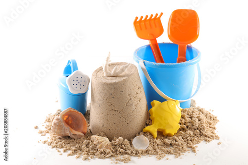 holiday concept, sand and baby toy