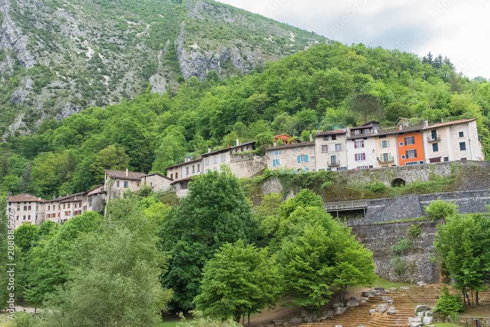 Pont-en-Royans in the Vercors, typical colorful houses built on the cliff, over the river, in France 
