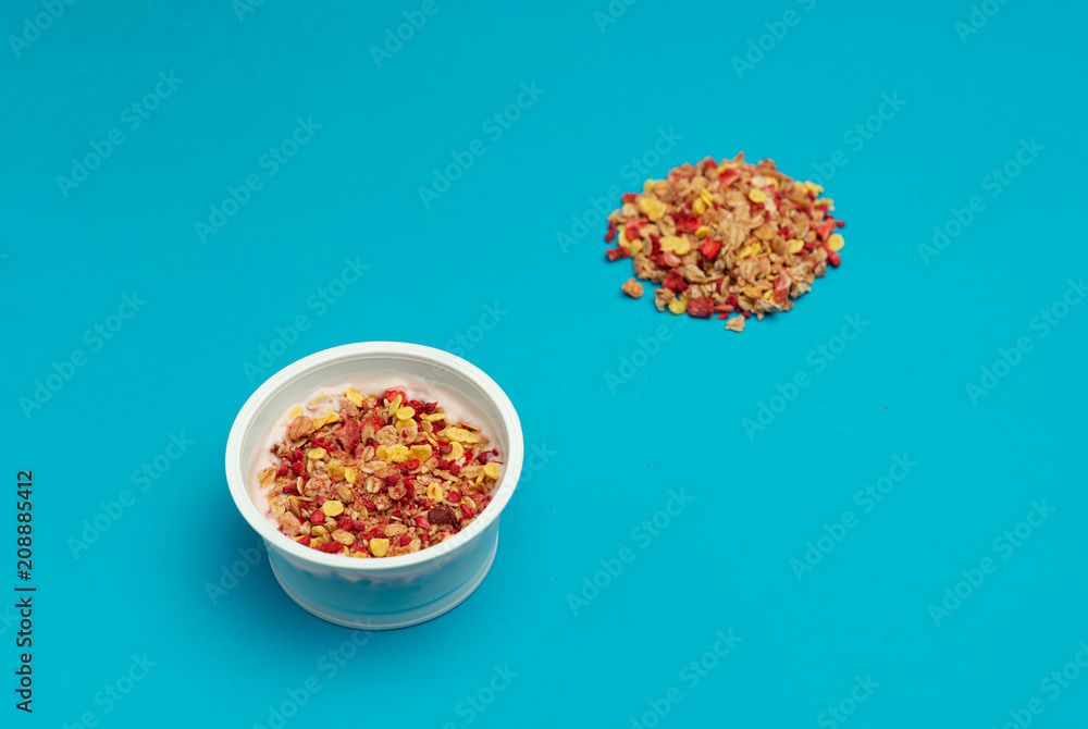 desserts yogurt and cereals, strawberry and raspberry. On blue background desserts yogurt and cereals, strawberry and raspberry. On blue background