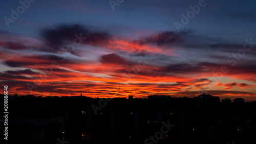 Fototapeta Naklejka Na Ścianę i Meble -  sunset sky with orange clouds on the city. Background wallpaper